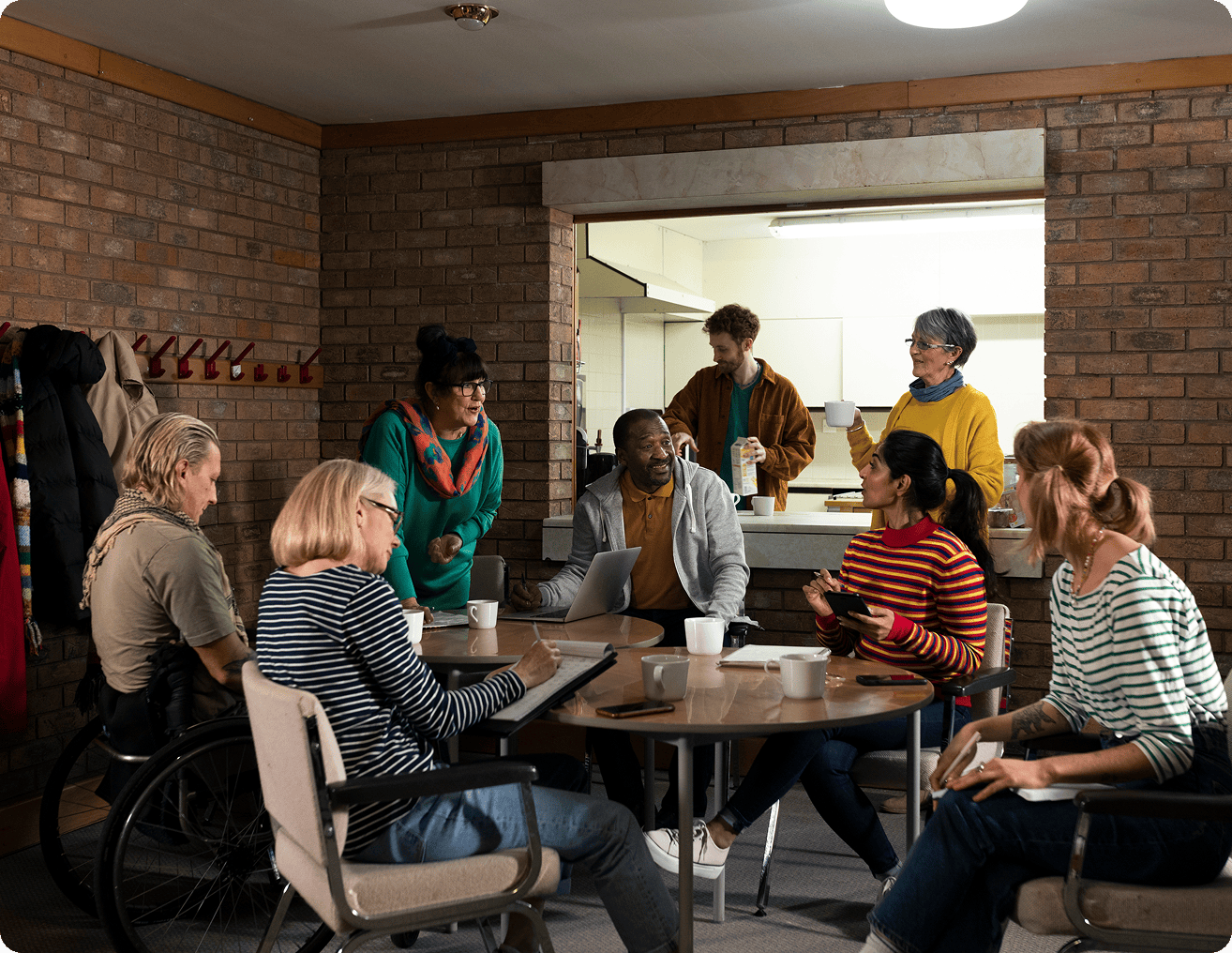 Group of people sitting around a table in a room